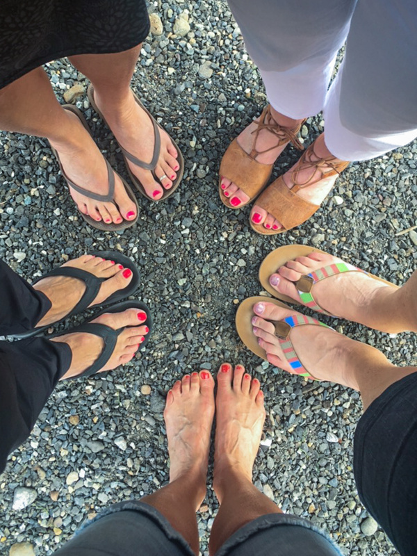 Group of female feet in a circle. Top view.